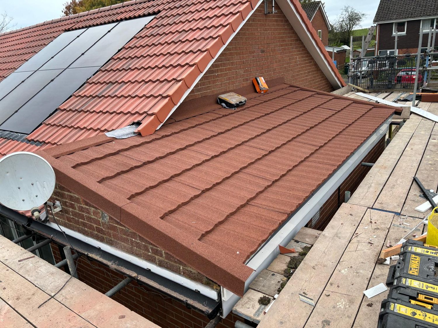 Completed red tiled roof with integrated solar panels