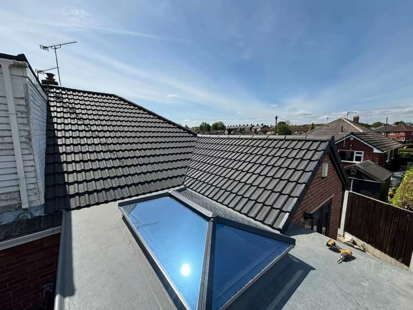Completed re-roof with new tiles, flat roof section and roof lantern