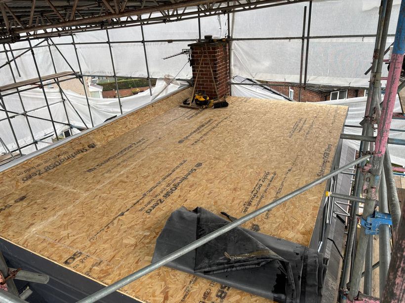 Dormer roof deck boarded out with scaffolding around it