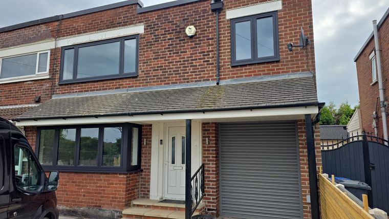 Front of a house with new roofline and guttering