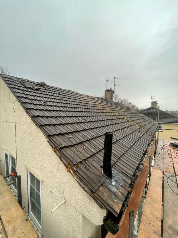 Grey tiled roof with new ridge and finished roofline
