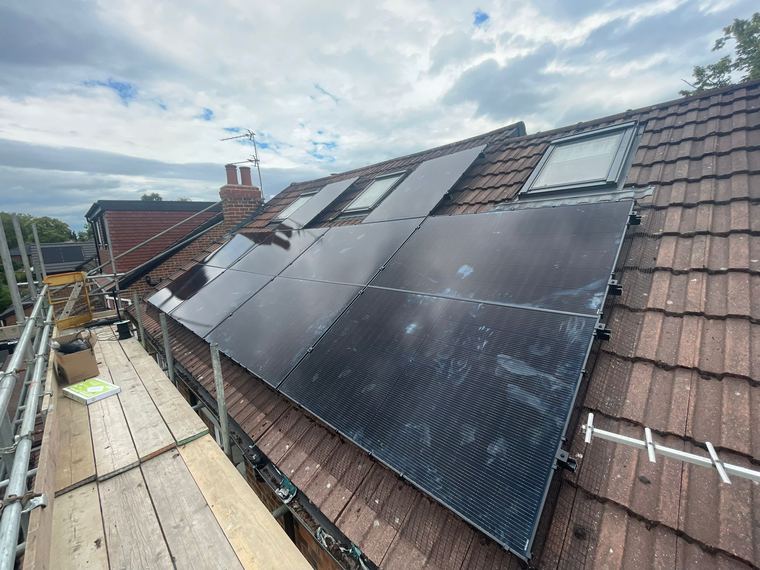 Solar panels fitted alongside an existing roof window